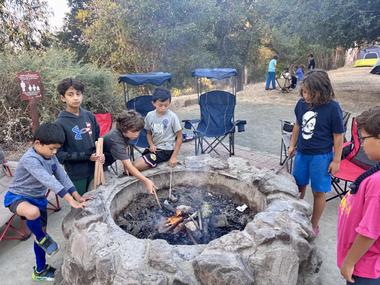 Pack 212 Scouts gathered around a campfire